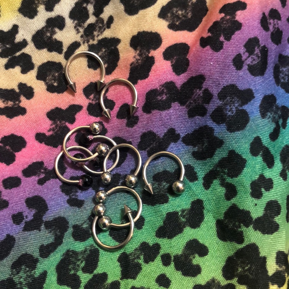 Lots of rings piercings earrings lip belly rings